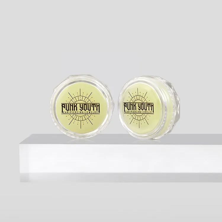 1 baume pour étirer et percer les oreilles + 1 outil de mesure de la taille