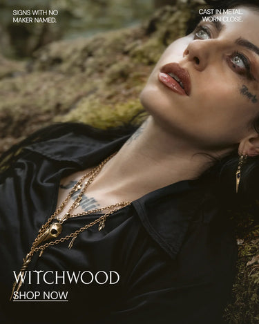 Woman with tattoos and gold necklace against a natural background, with 'Witchwood' branding.