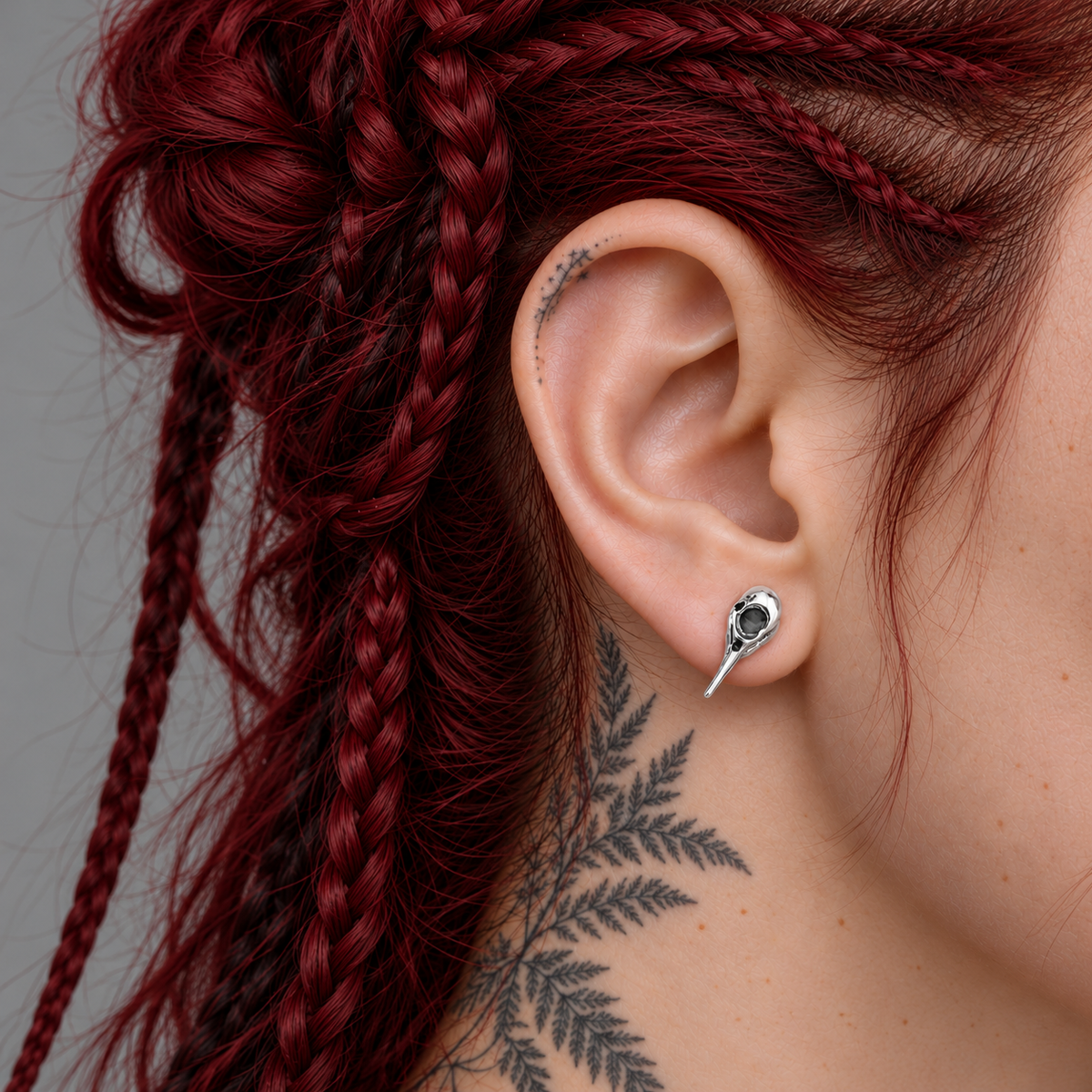 Carrion Bird Skull Ear Stud worn on the ear