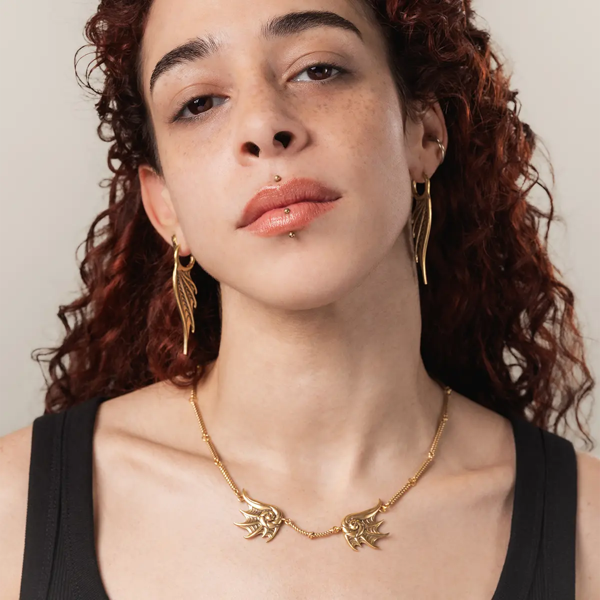 Model wearing the gold Abyssal Bind Necklace with shell-like ridges, a short rope chain center, and dark coastal gothic styling.