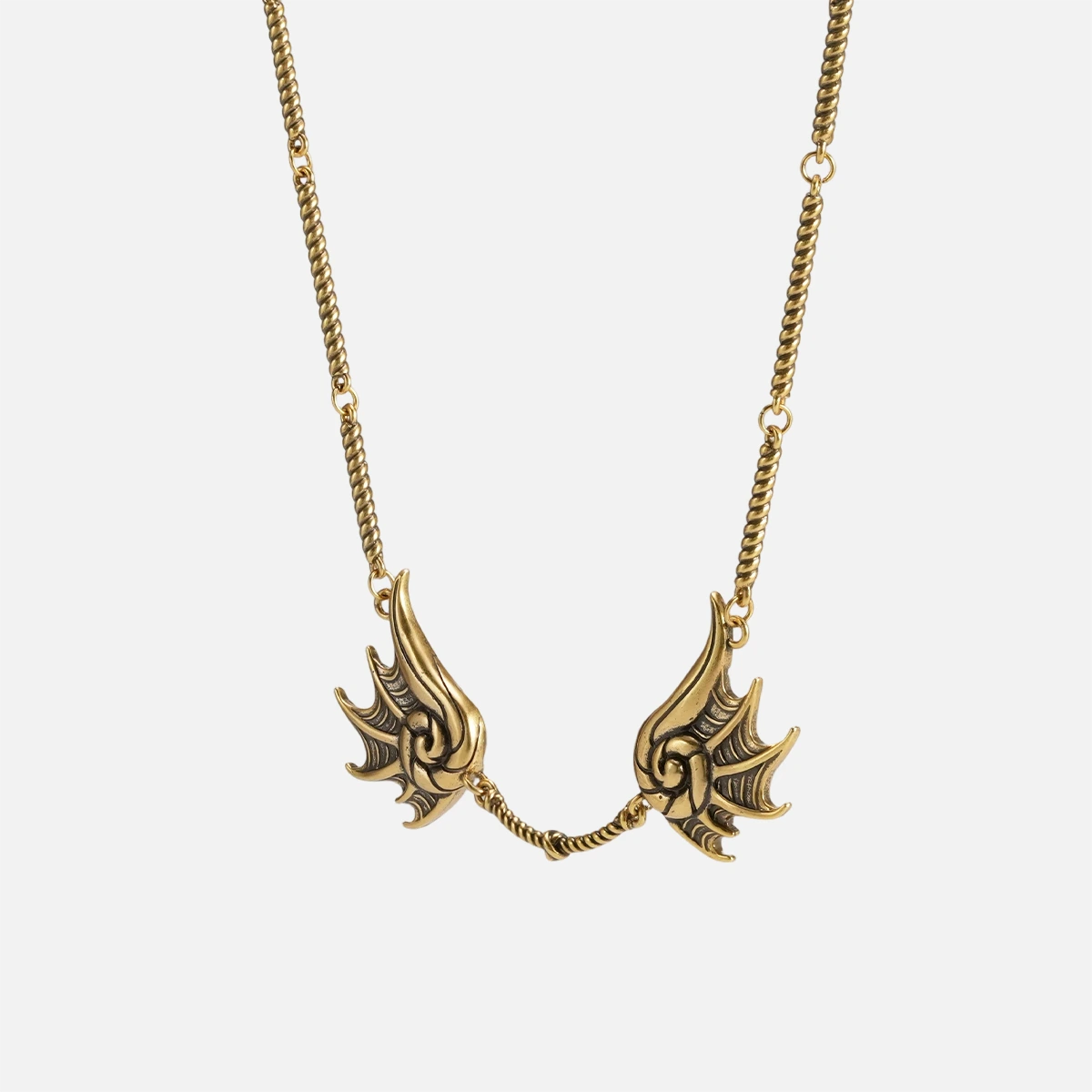 Gold Abyssal Bind Necklace with twin conch-like forms, shell ridges, and central tether detail on a clean background.