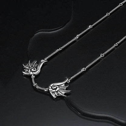 Silver Abyssal Bind Necklace displayed on a dark wet surface, featuring shell-like ridges, a central tether detail, and sea-worn gothic mood.