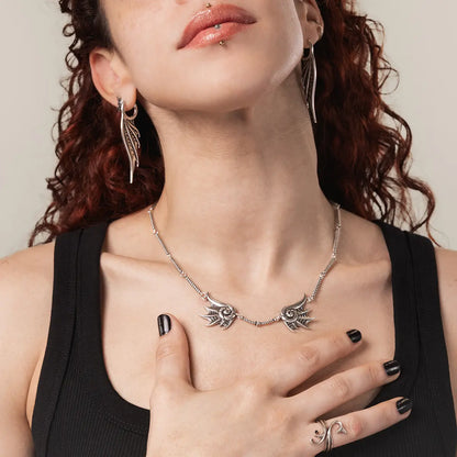 Model wearing the silver Abyssal Bind Necklace with layered gothic jewelry, highlighting its sharp horizontal silhouette and ocean relic mood.