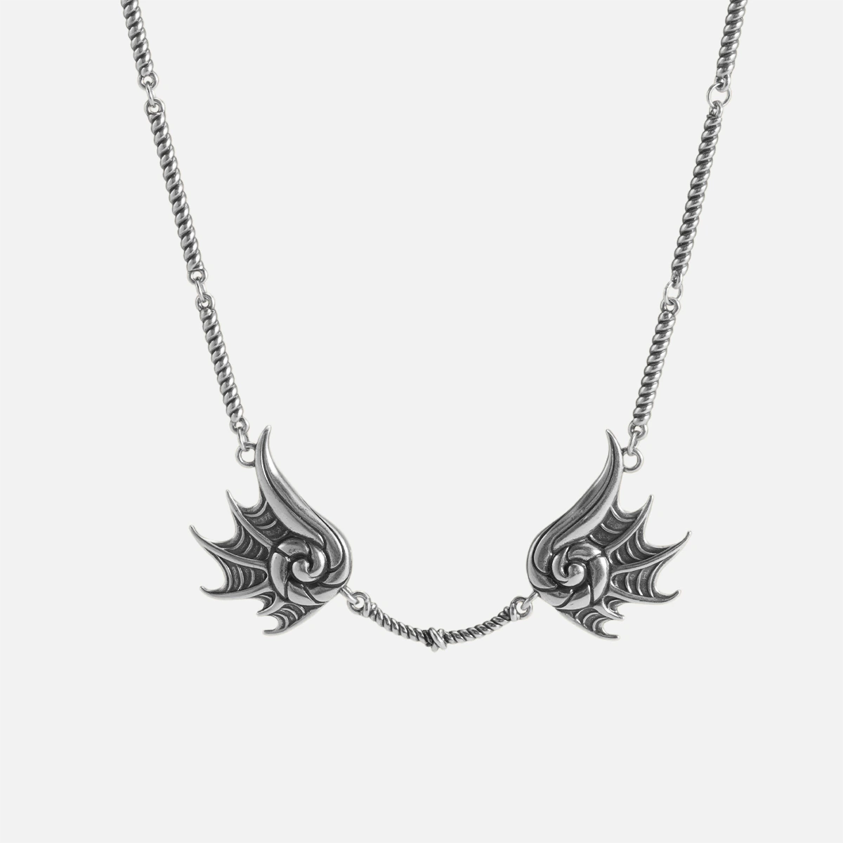 Silver Abyssal Bind Necklace with twin conch-like forms, shell ridges, central rope chain detail, and antiqued finish on a clean background.