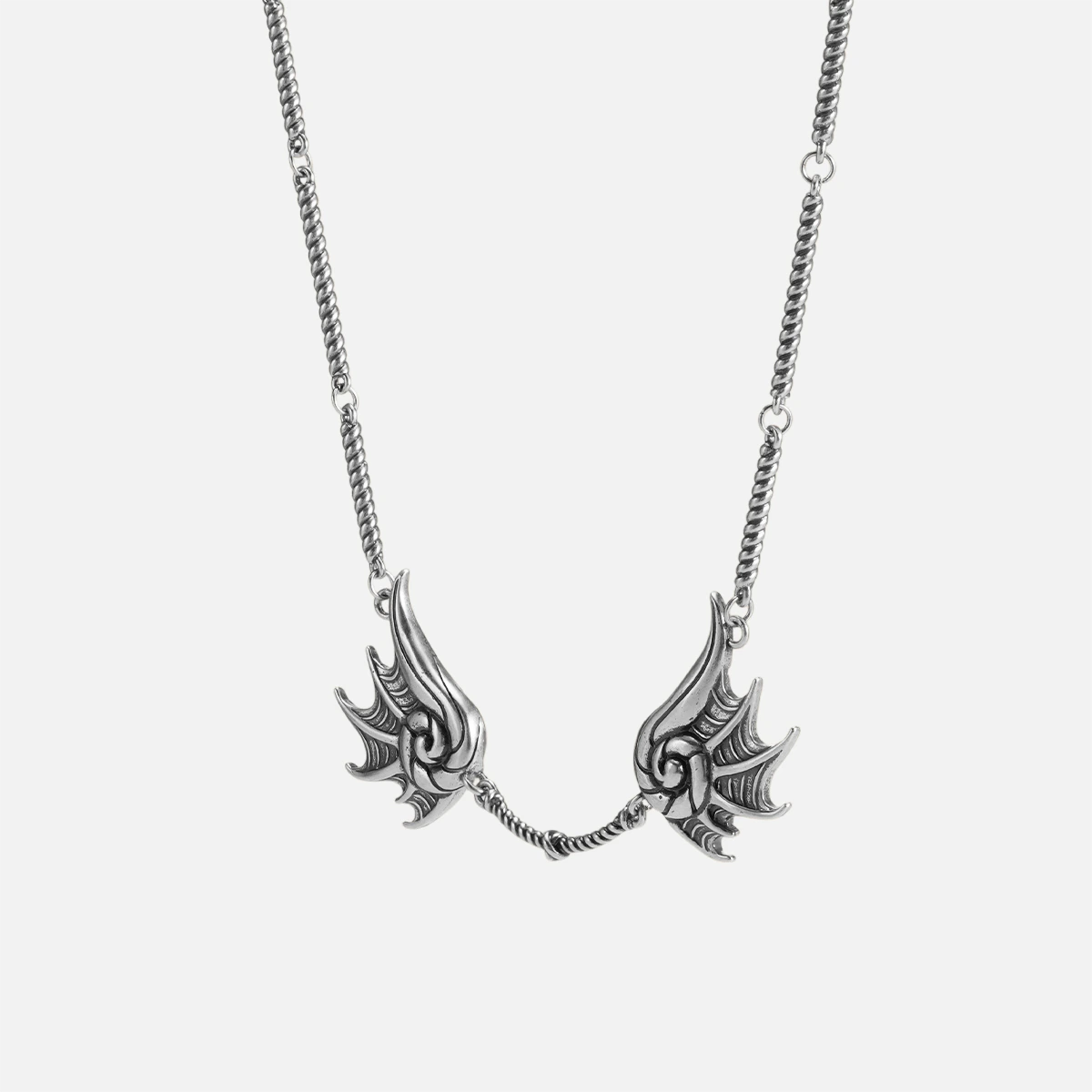 Silver Abyssal Bind Necklace with twin shell-like side pieces, central rope chain detail, and antiqued gothic finish on a clean background.