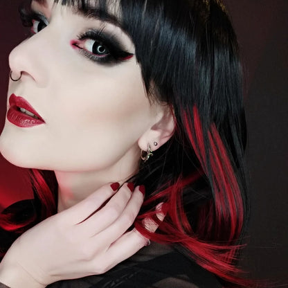 Adaptive Evolution Earrings in 925 sterling silver, worn in a black-and-red hair portrait with a hand at the neck and dramati
