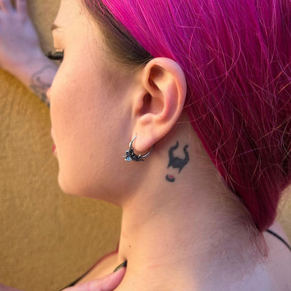 Adaptive Evolution Earrings in 925 sterling silver, worn in a rear-side ear view with magenta hair and a black neck tattoo.