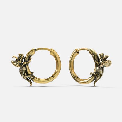 Pair of gold Adaptive Evolution hoop earrings with small skeletal creature details