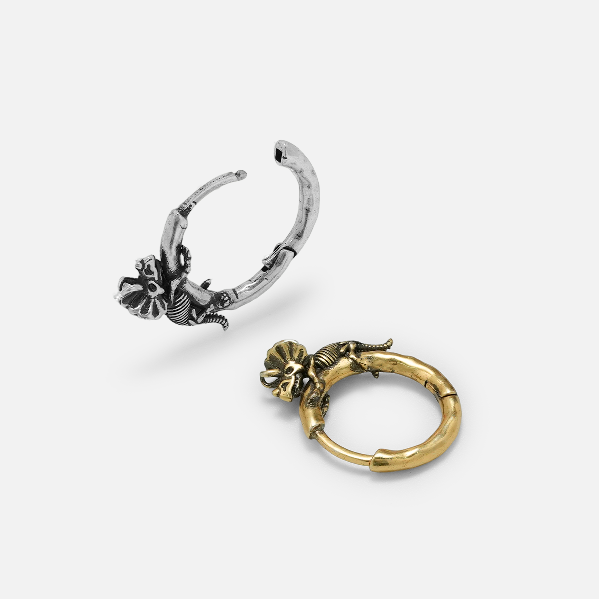 Silver and gold Adaptive Evolution hoop earrings shown open and lying flat