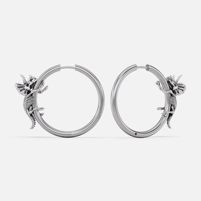 Pair of silver Adaptive Evolution hoop earrings with small creature details