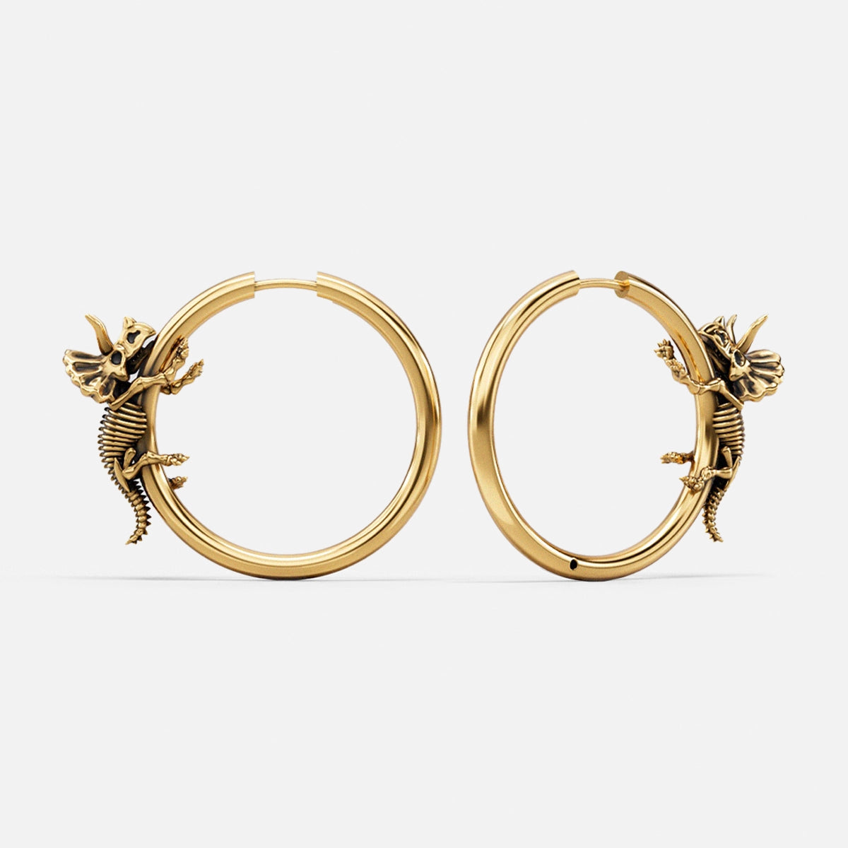 Pair of gold Adaptive Evolution hoop earrings with small creature details
