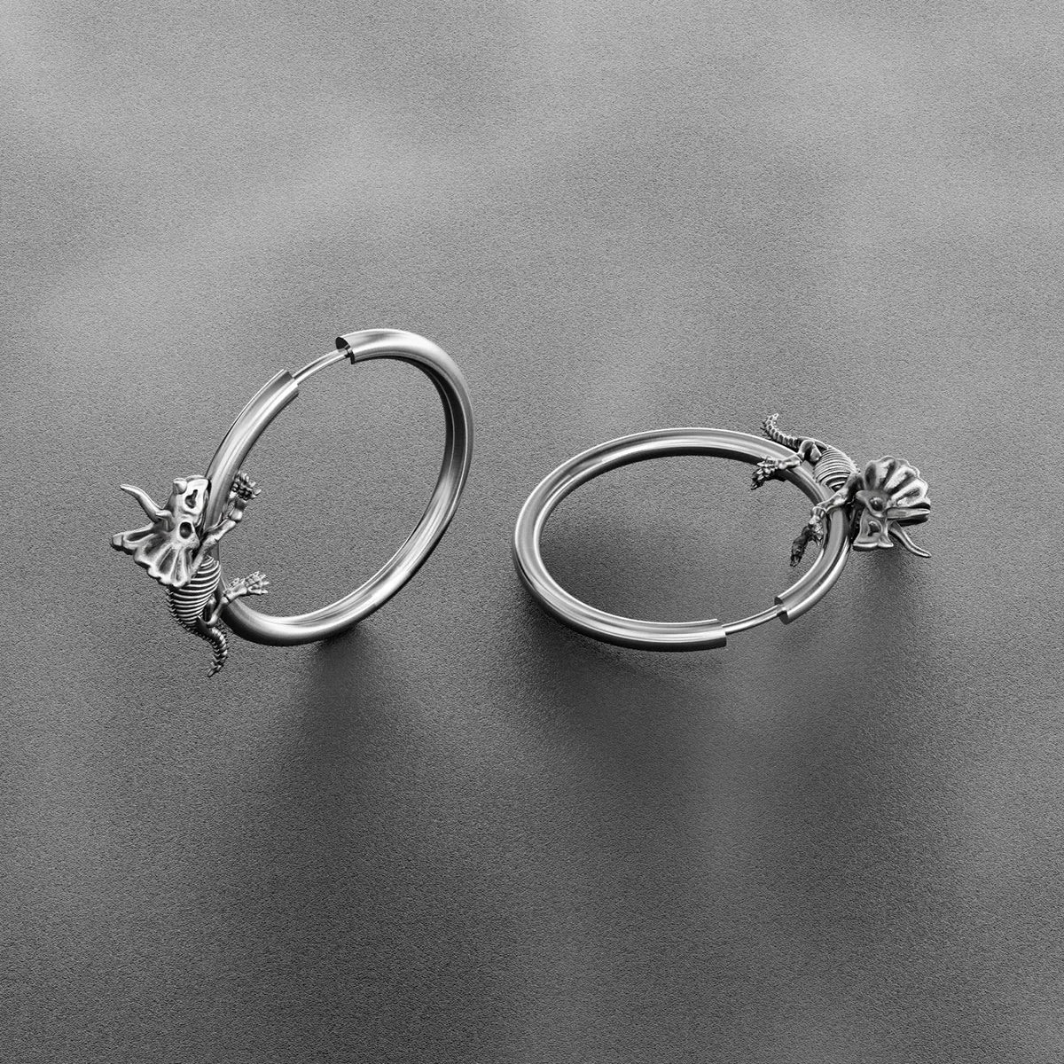 Pair of silver Adaptive Evolution hoop earrings shown open and closed