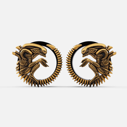 Pair of gold Alien Invasion tunnels with curled biomechanical creature design