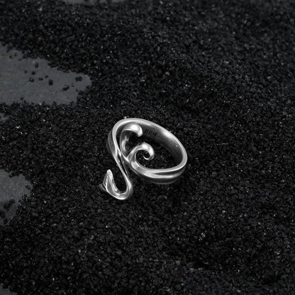 Alternative fashion silver wave ring with antiqued finish on dark coastal black sand