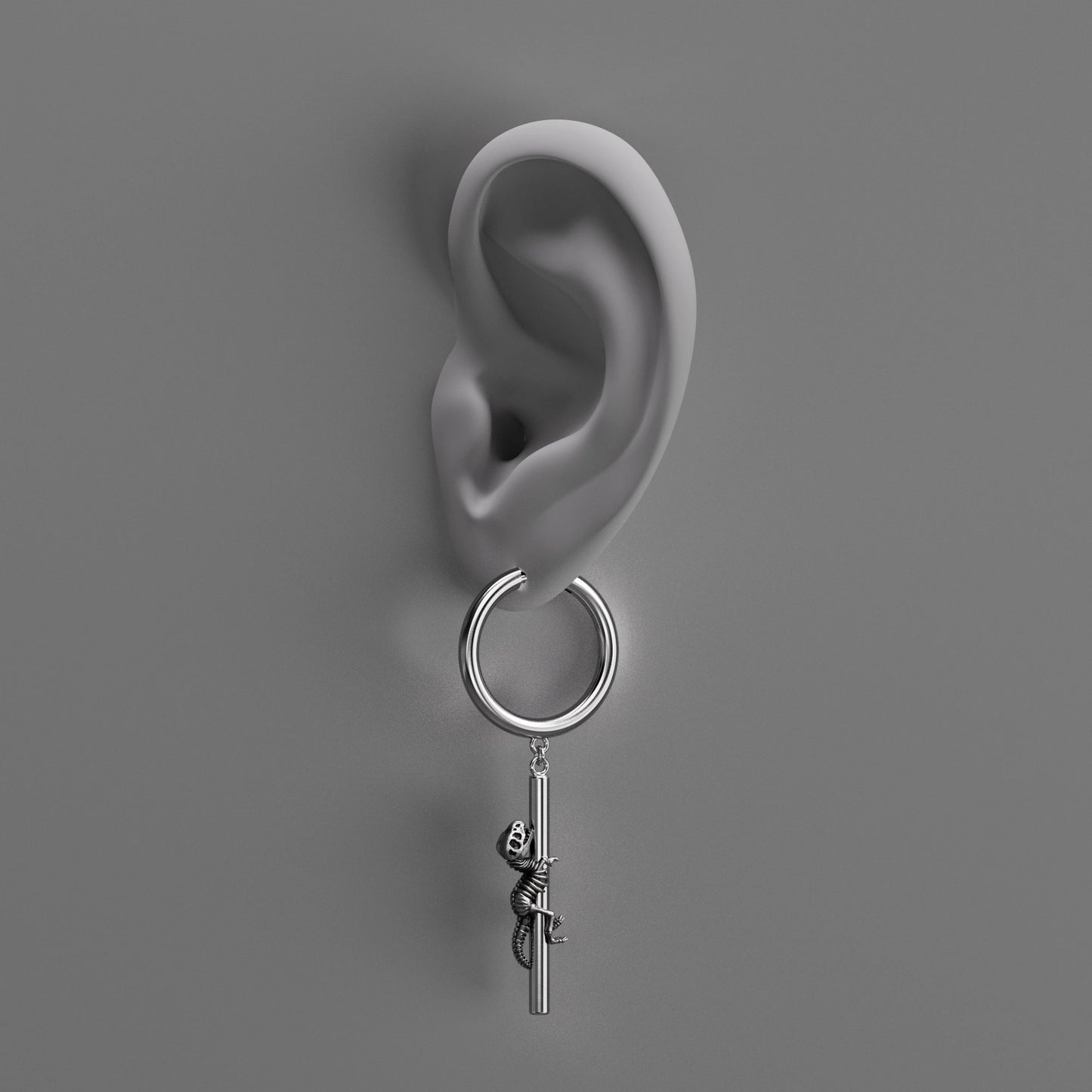 Silver Ancient Dragon Fossil drop earring shown on an ear illustration