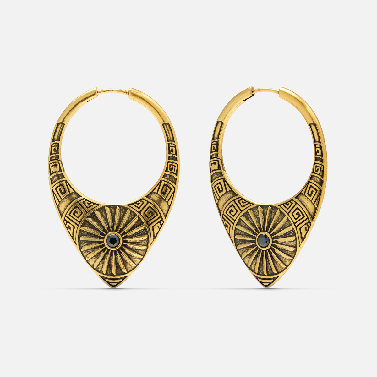 Pair of antique gold-tone hoop earrings featuring a sunburst medallion and geometric etched pattern
