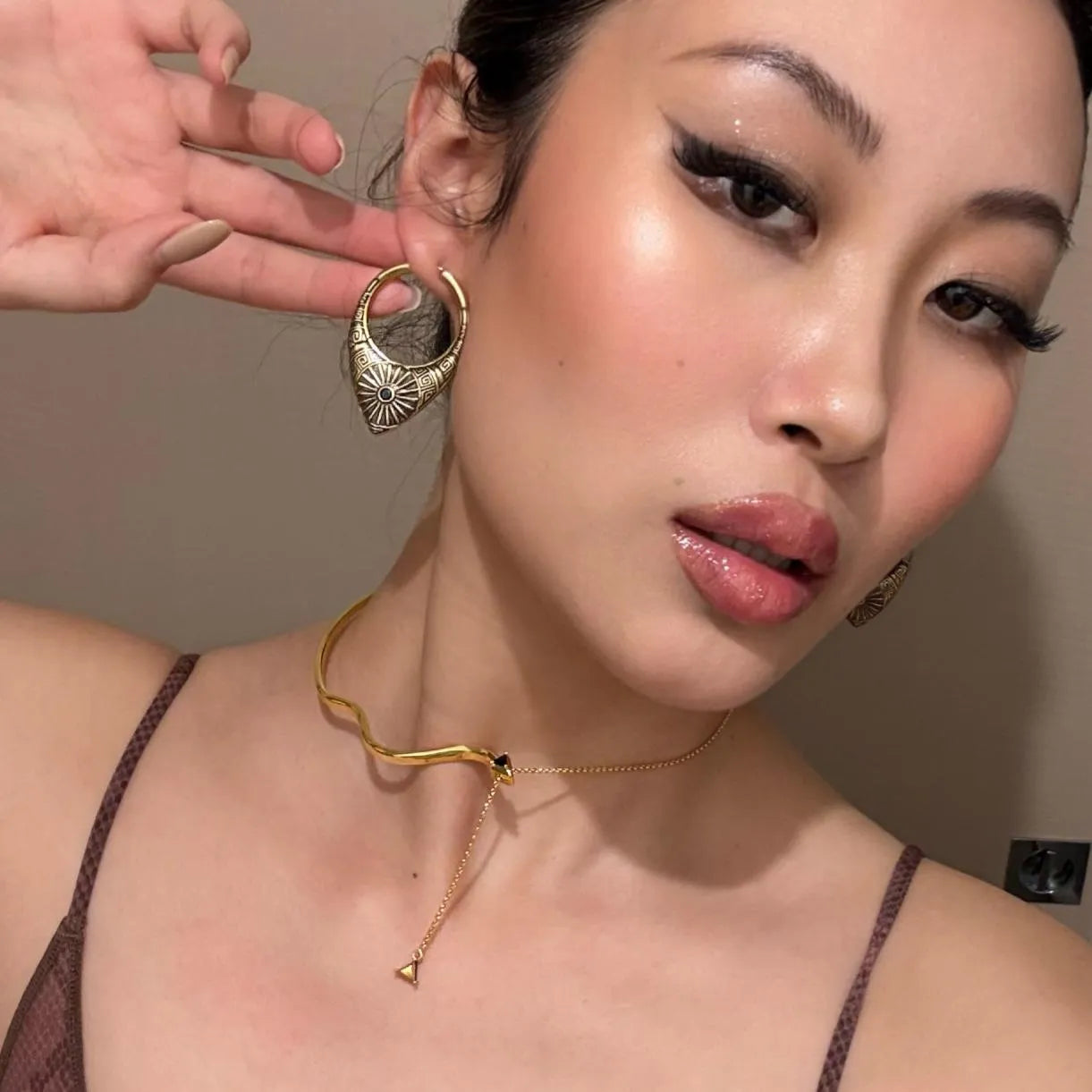 Gold Ancient Sun Earrings styled on model with sunburst teardrop hoop and celestial tribal jewelry look