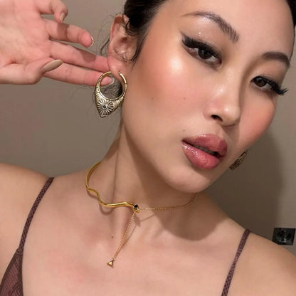 Gold Ancient Sun Earrings styled on model with sunburst teardrop hoop and celestial tribal jewelry look
