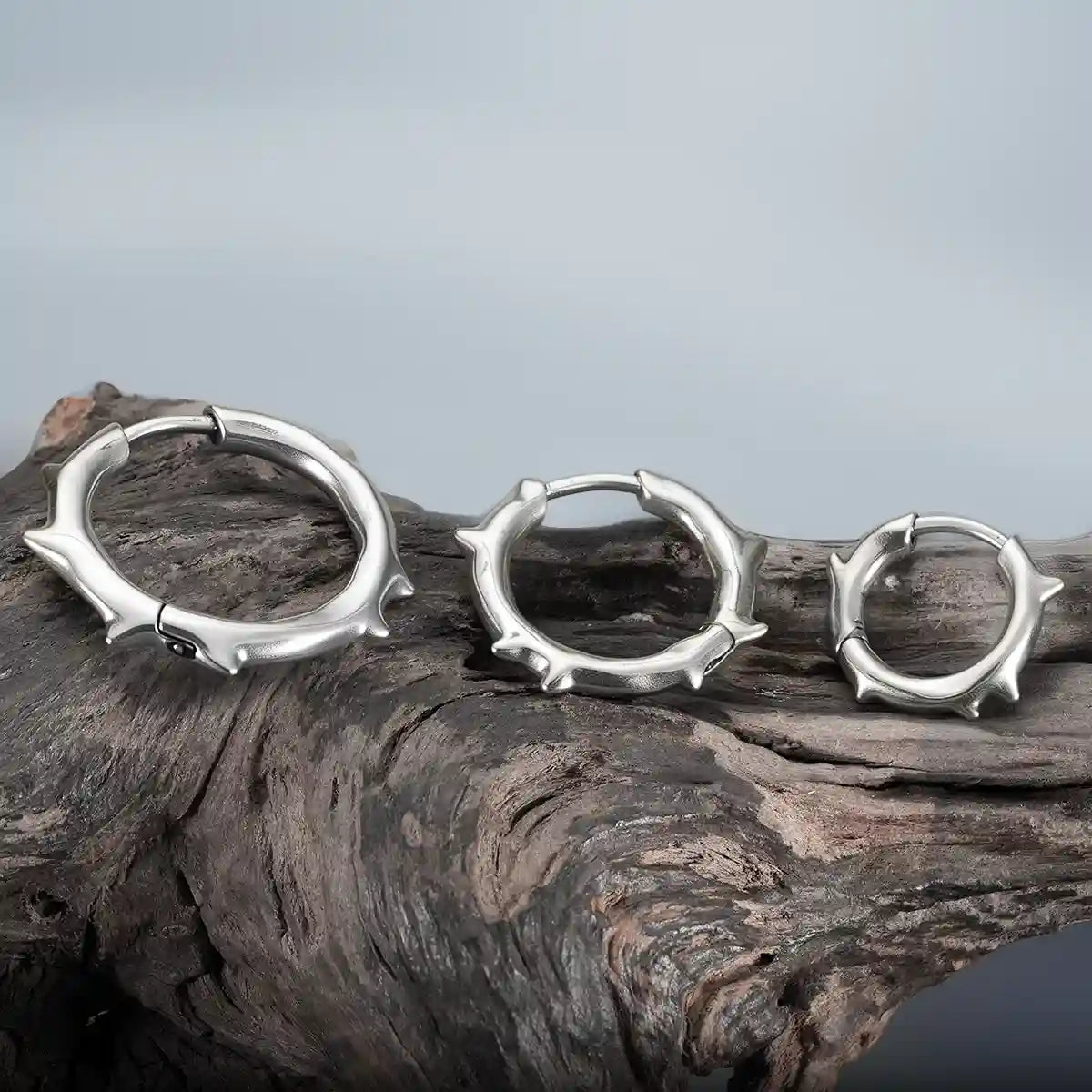 Silver Ancient Thorn Hoops displayed on driftwood with antiqued thorn details