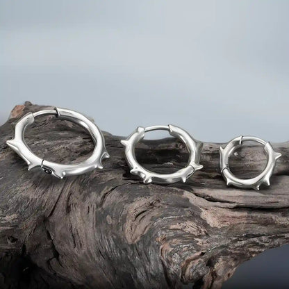 Silver Ancient Thorn Hoops displayed on driftwood with antiqued thorn details