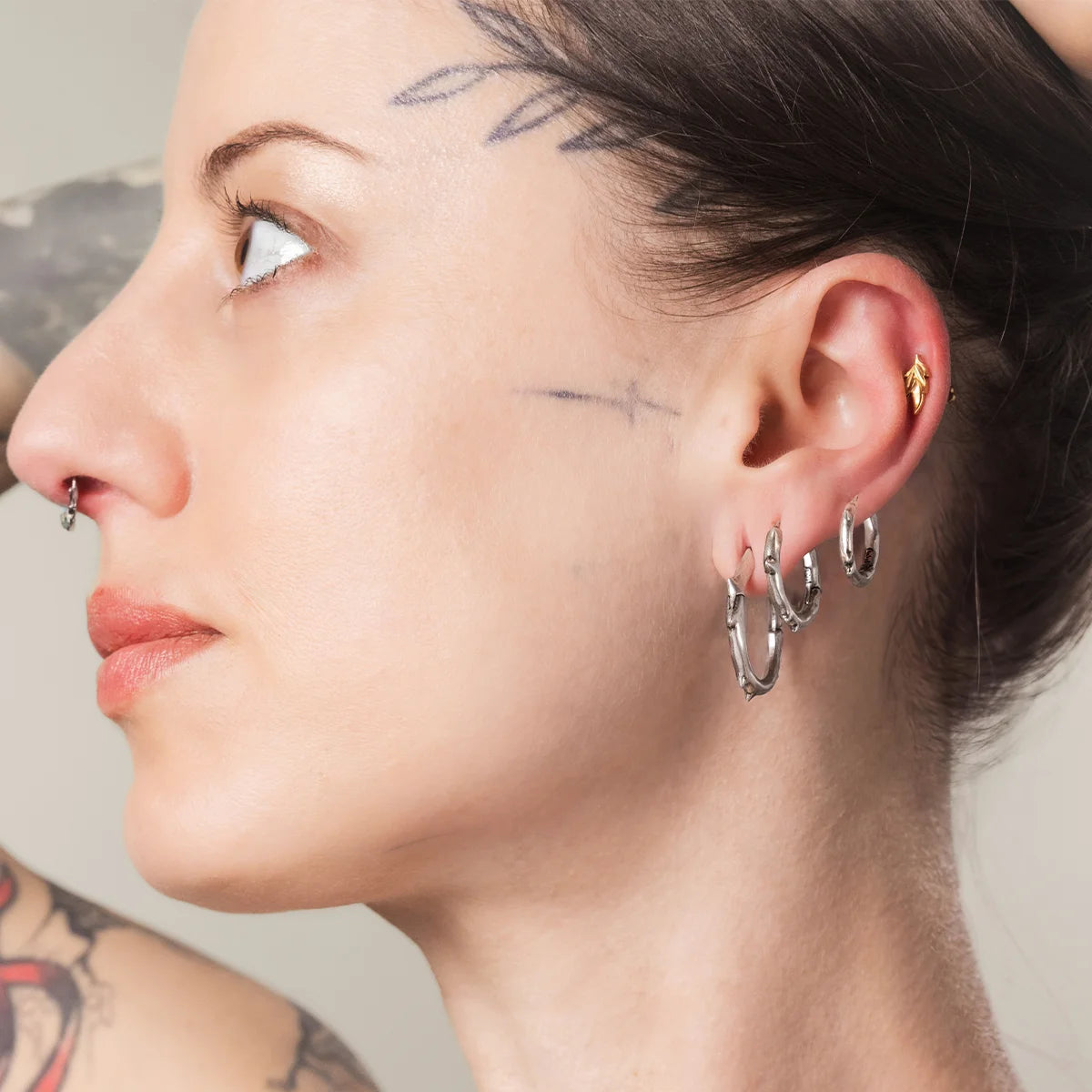 Silver Ancient Thorn Hoops styled on model with sharp bramble-inspired jewelry look