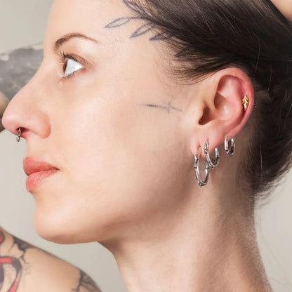 Silver Ancient Thorn Hoops styled on model with sharp bramble-inspired jewelry look