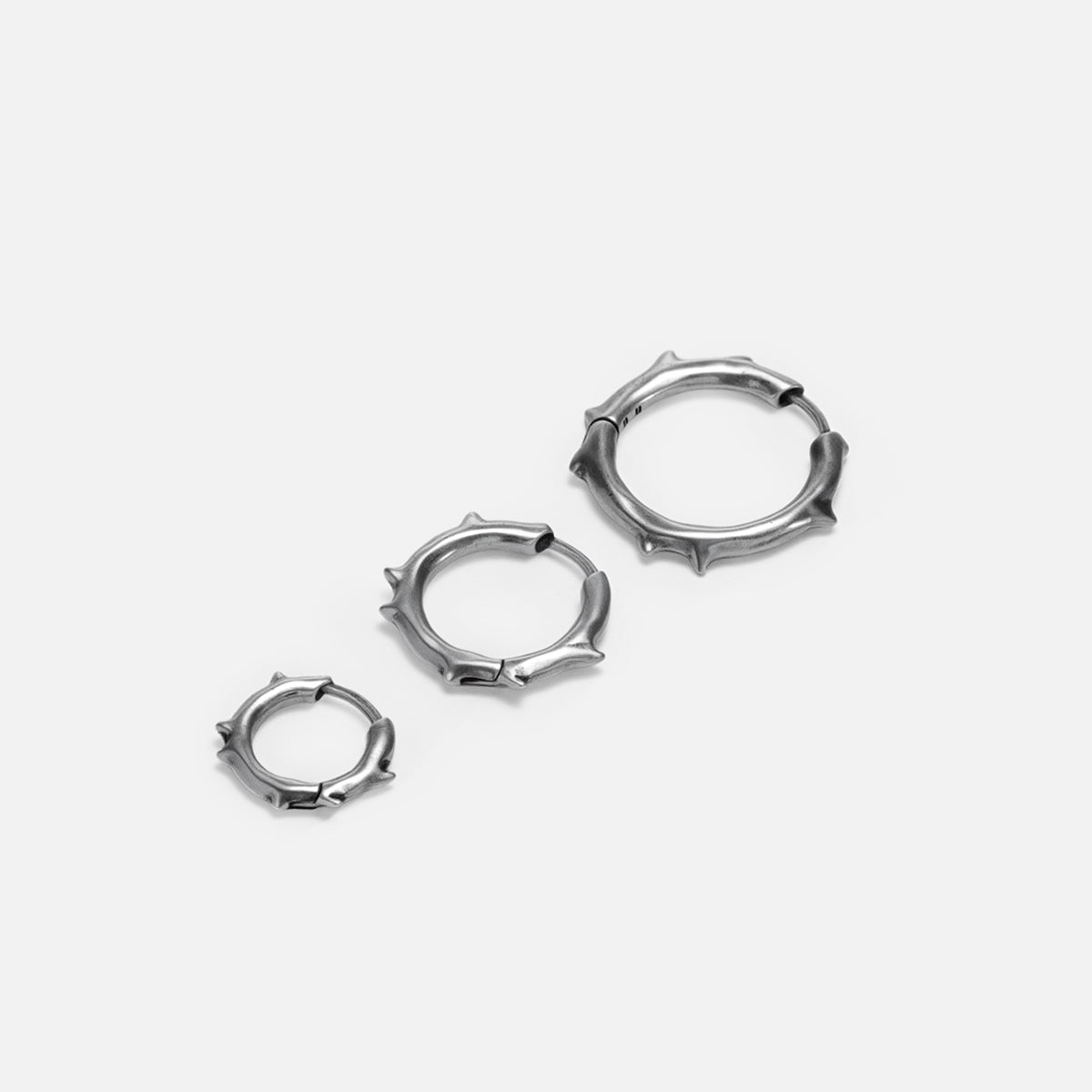 Ancient Thorn Hoops in silver-tone brass shown in multiple sizes with thorn-shaped spike details