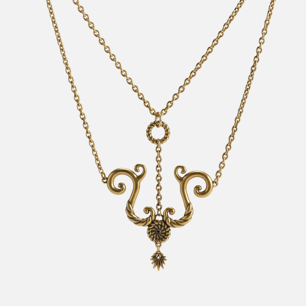 Antiqued brass finish tideworn knot necklace with a stainless steel chain on plain white background