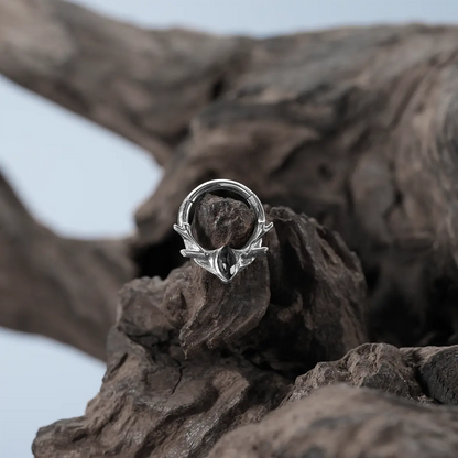 Silver Antler Mark Clicker displayed on driftwood with dark woodland jewelry styling