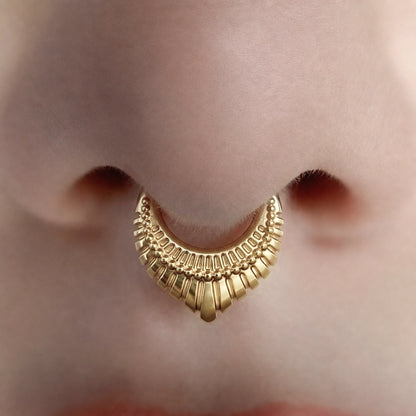Gold-tone Artisan Inspired Clicker worn as a septum ring, showing its textured layered design.