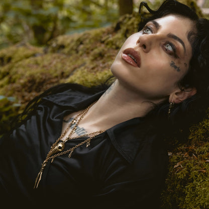 Augur Skull Necklace worn by model in dark forest setting with woodland relic styling