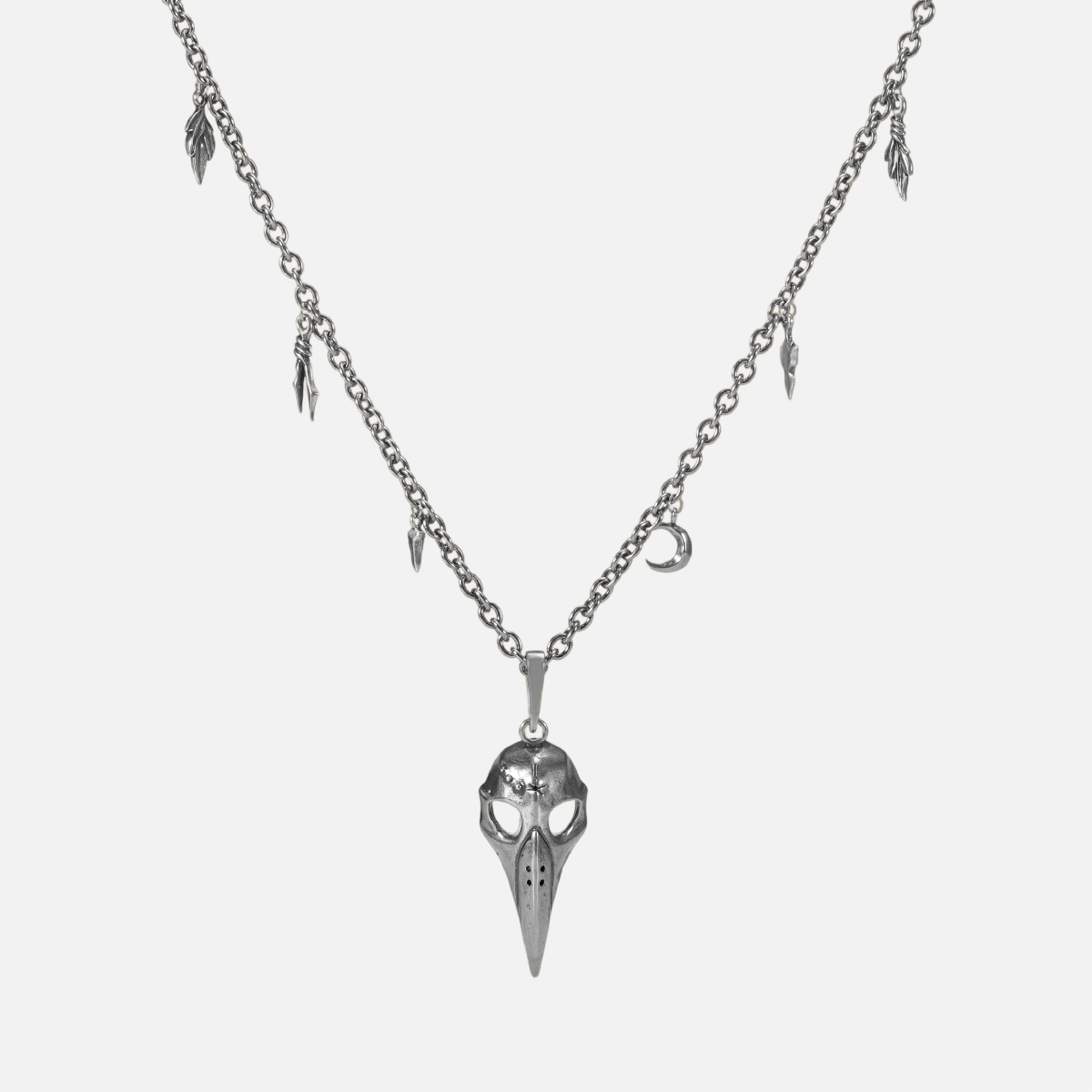 Augur Skull Necklace in silver plating with bird skull pendant, leaf charms, and antiqued finish