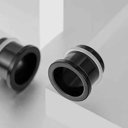Black Aurora ear tunnel shown at an angle beside a second tunnel on a white geometric display