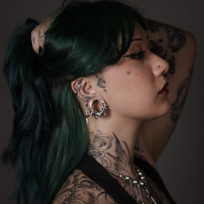 Model with green hair wearing a silver Bat Whisper tunnel