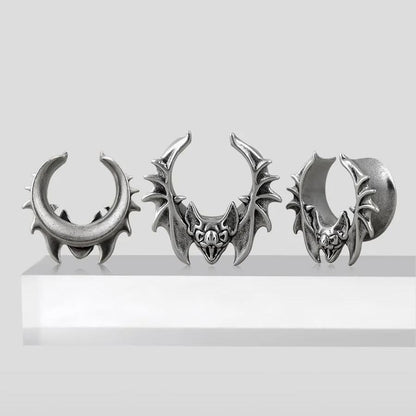 Three sizes of silver Bat Whisper tunnels displayed on a white pedestal