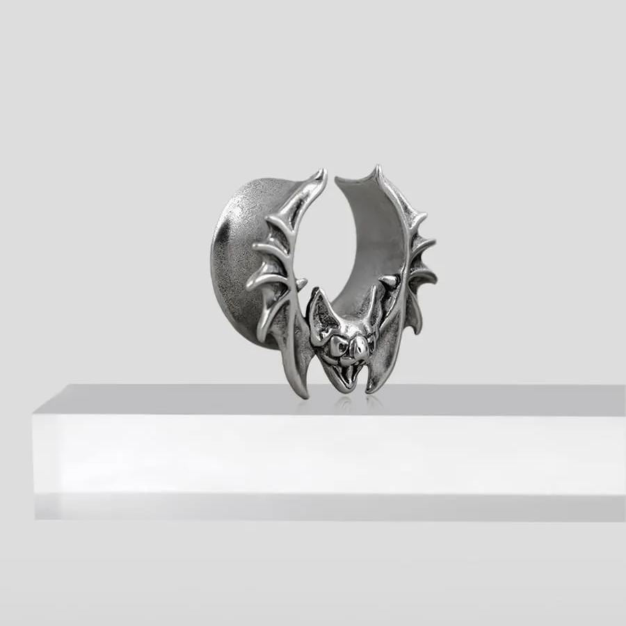 Single large silver Bat Whisper tunnel displayed on a white pedestal
