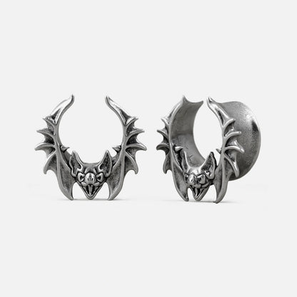 Silver-tone bat whisper tunnel earrings with detailed wings, shown front and side view