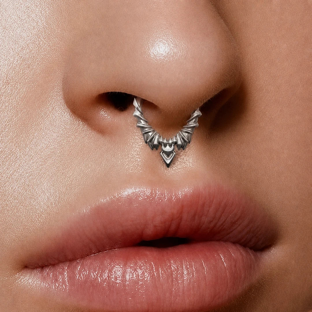 Silver-tone Bat Wing Clicker worn as a septum ring, featuring a layered gothic wing design.