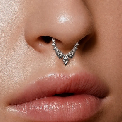 Silver-tone Bat Wing Clicker worn as a septum ring, featuring a layered gothic wing design.