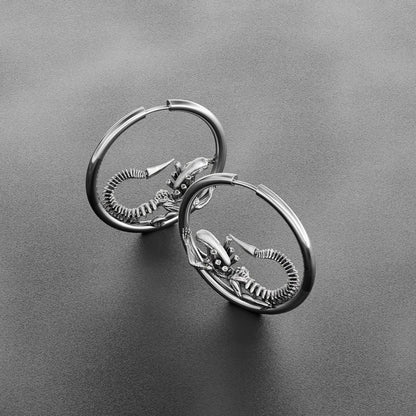 Pair of silver Biomechanical Alien hoop earrings with curled skeletal creature details