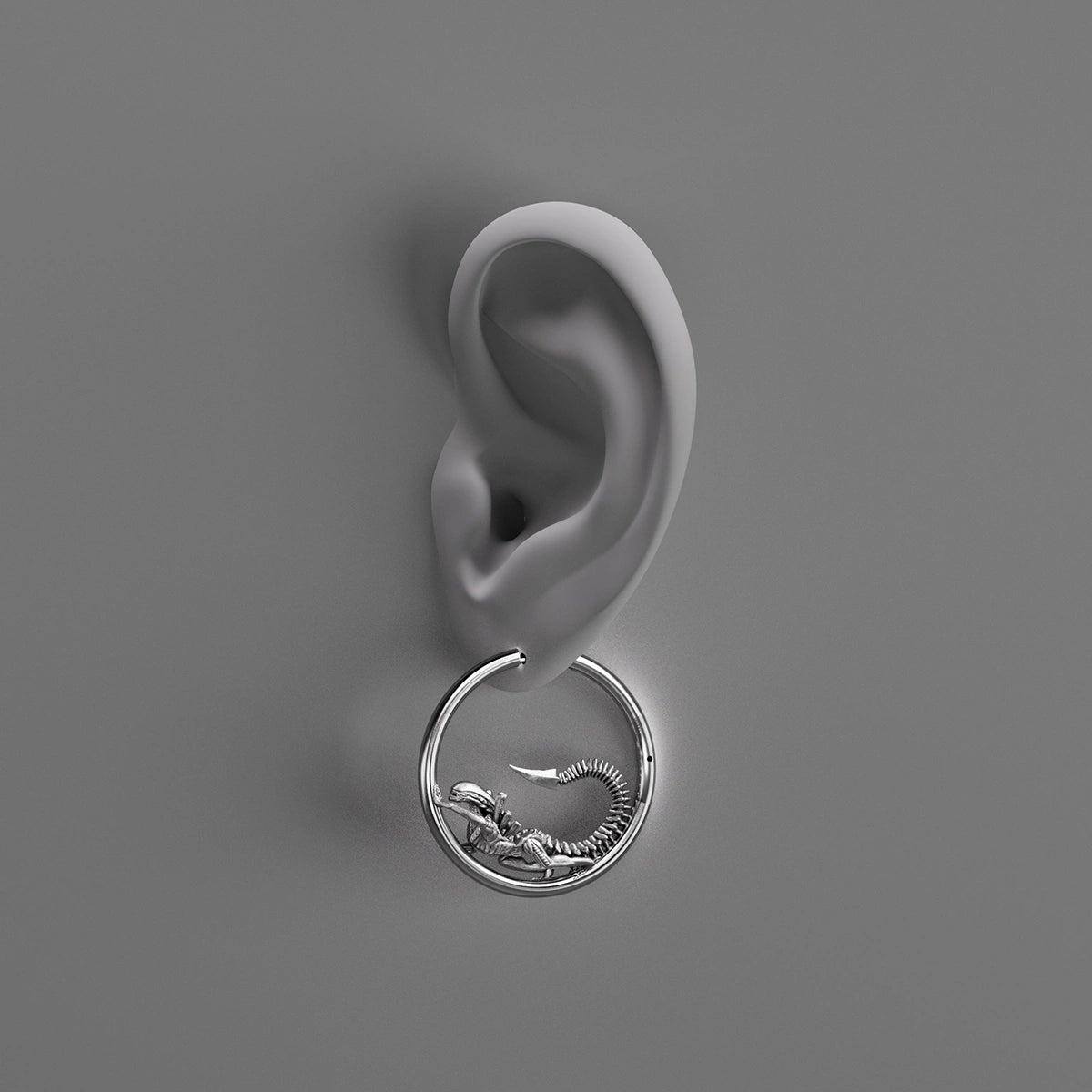Silver Biomechanical Alien hoop earring shown on an ear illustration