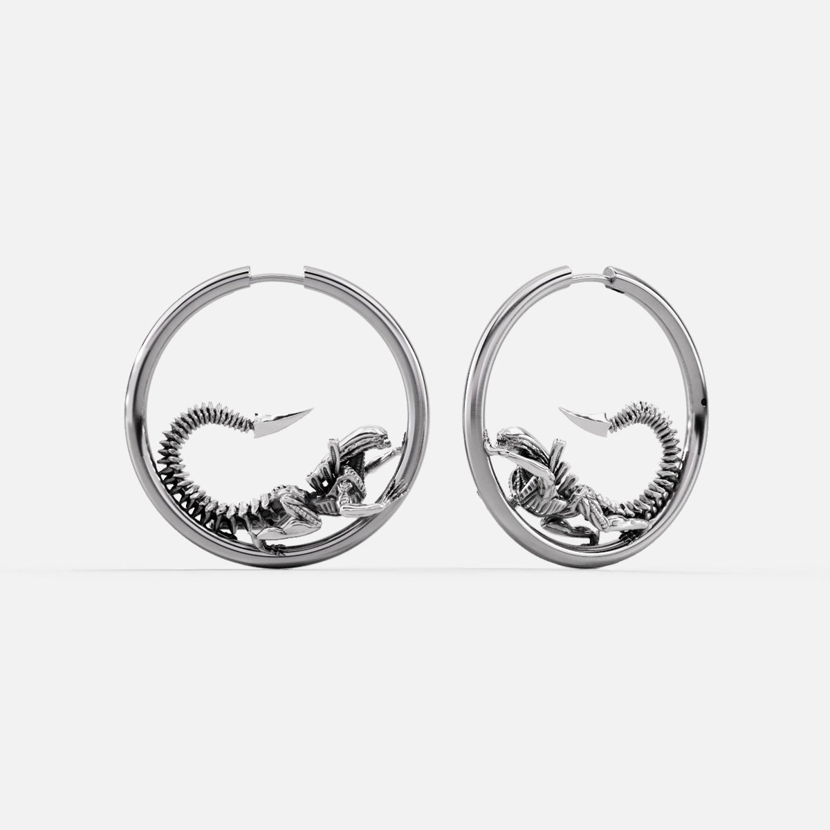 Silver-tone Biomechanical Alien hoop earrings with curled skeletal creature details