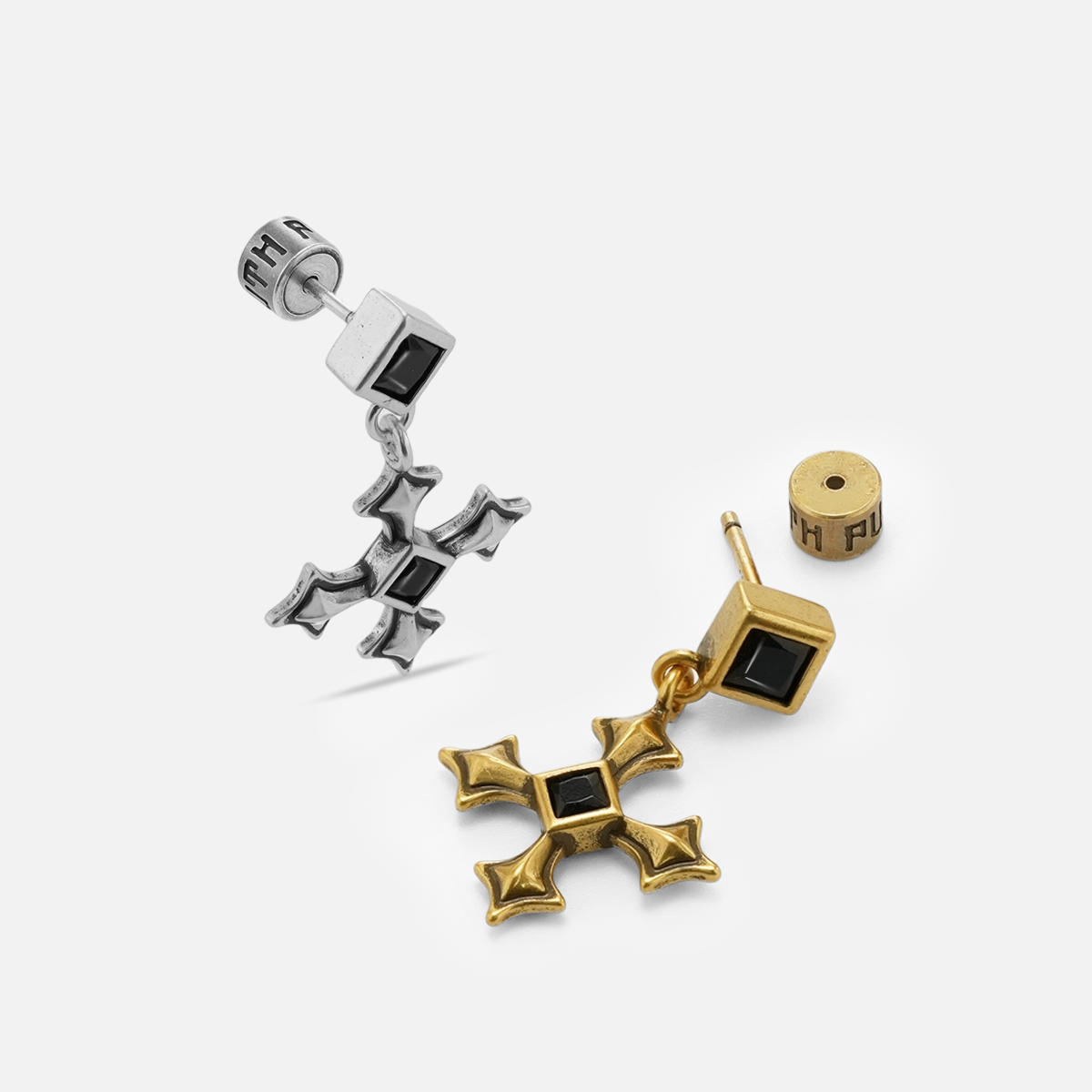 Silver and gold Black Testament Earrings arranged on white to show the cross drops, studs, and back construction.