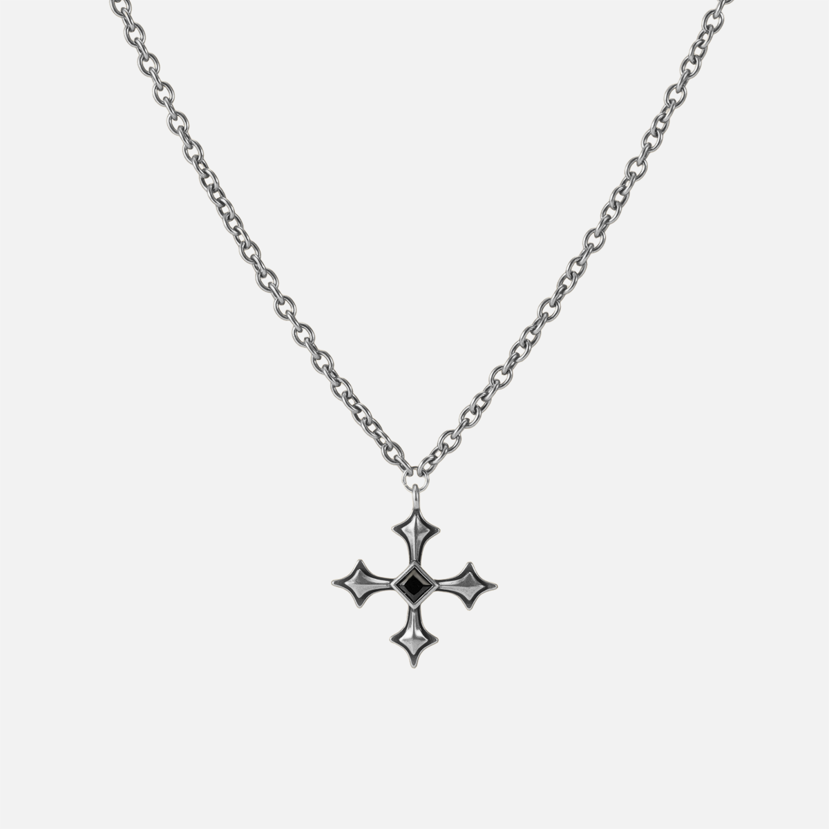 Black Testament Necklace in antiqued silver with a gothic cross pendant and black obsidian, shown full length on white.