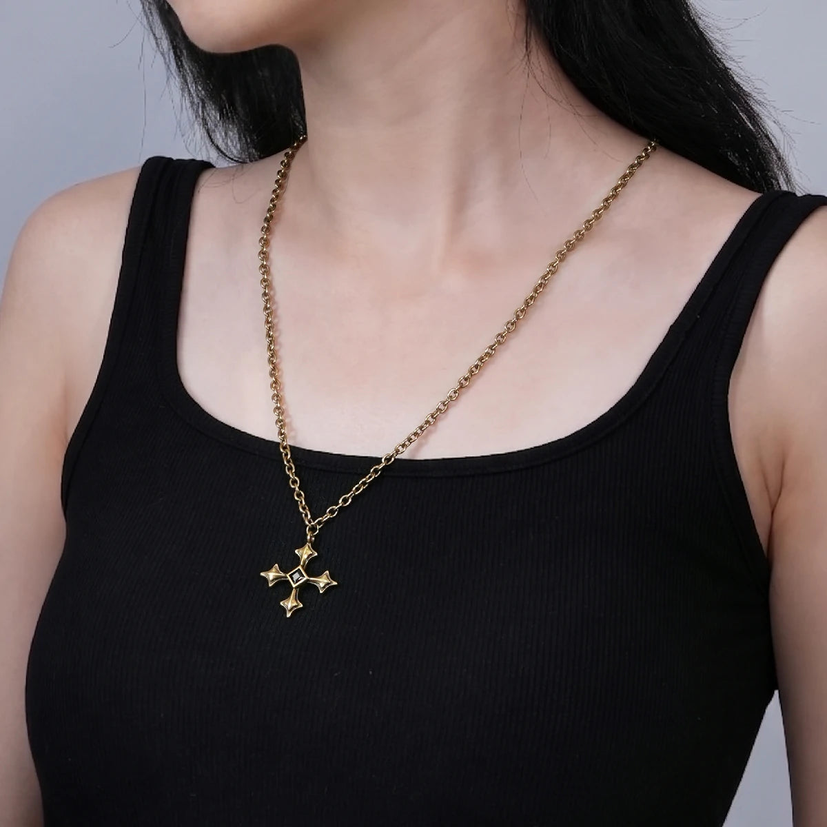 Black Testament Necklace in antiqued 18K gold worn over a black sleeveless top in a wider upper-body styling view.