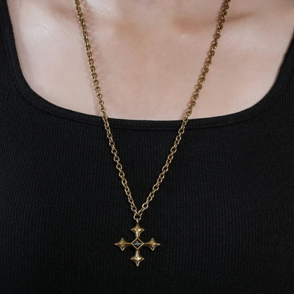 Black Testament Necklace in antiqued 18K gold worn centered over a black neckline in a close front crop.