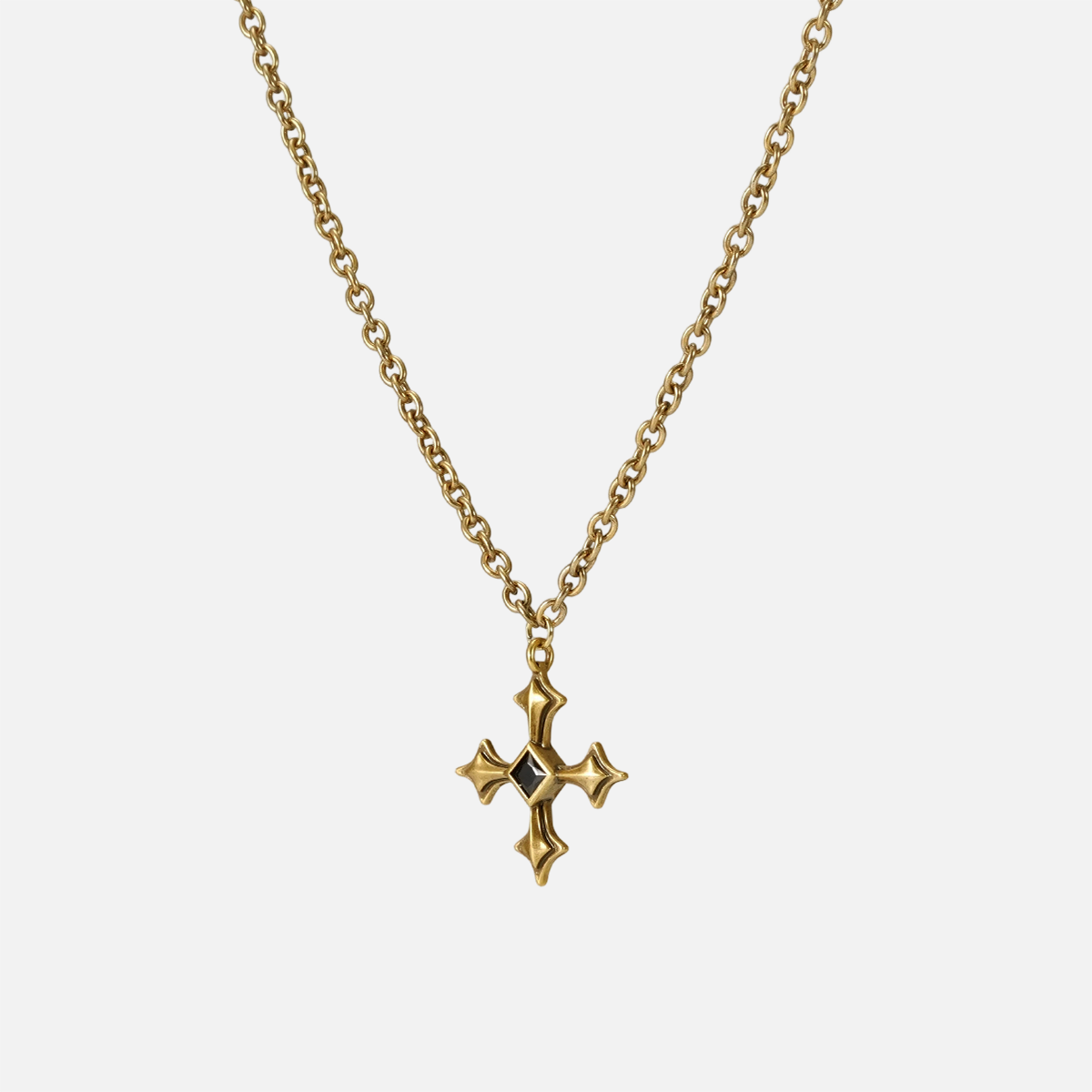 Black Testament Necklace in gold shown vertically on white, highlighting the gothic cross pendant and chain.