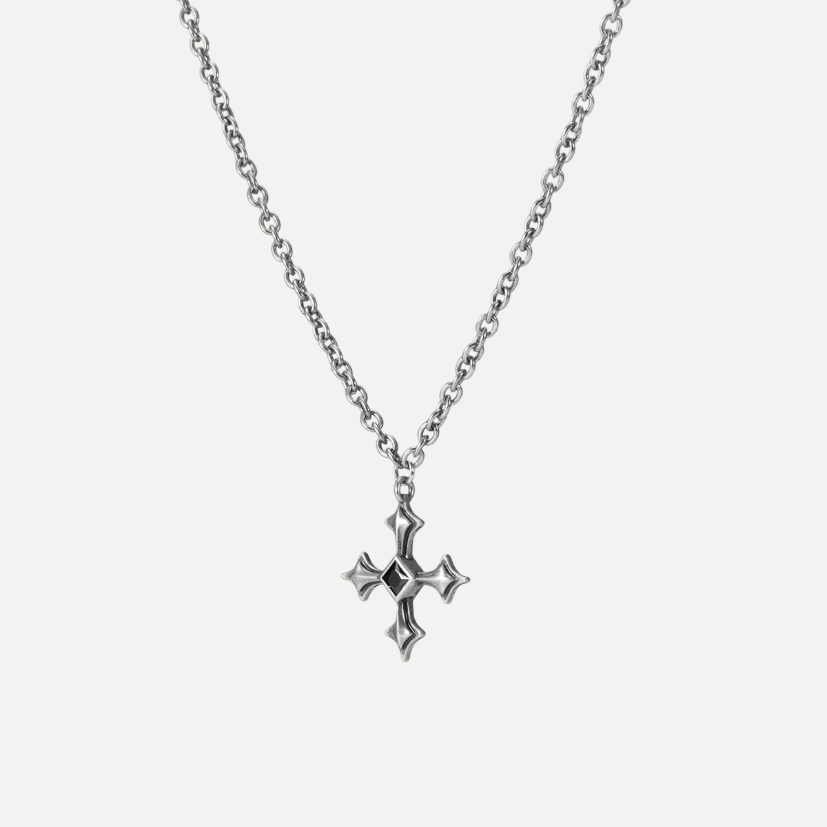 Black Testament Necklace in silver shown vertically on white, highlighting the gothic cross pendant and chain.