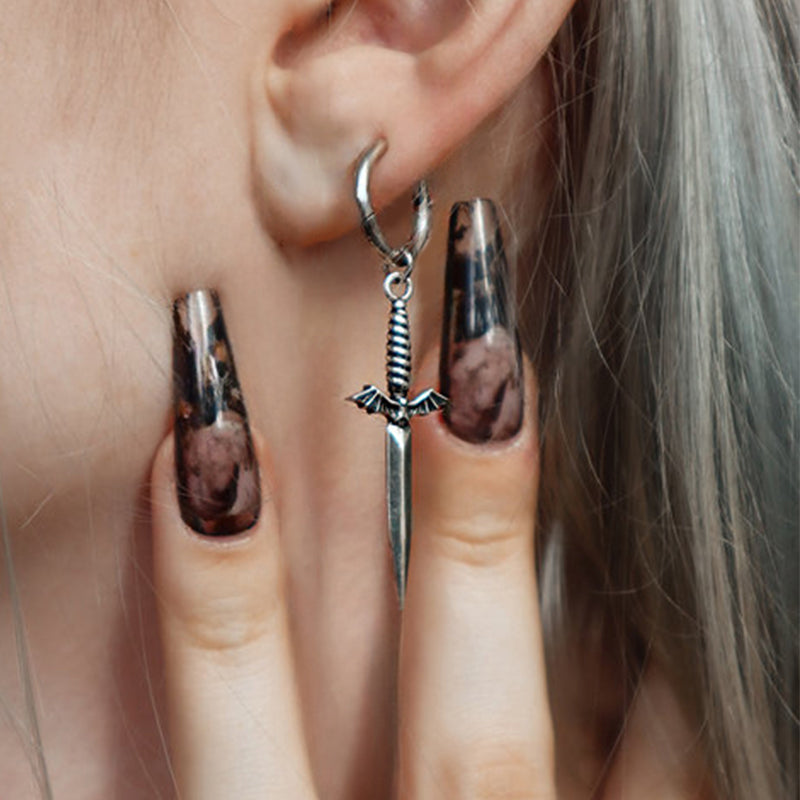 Blade wing earring with bat-shaped hilt shown close up dangling from a small hoop