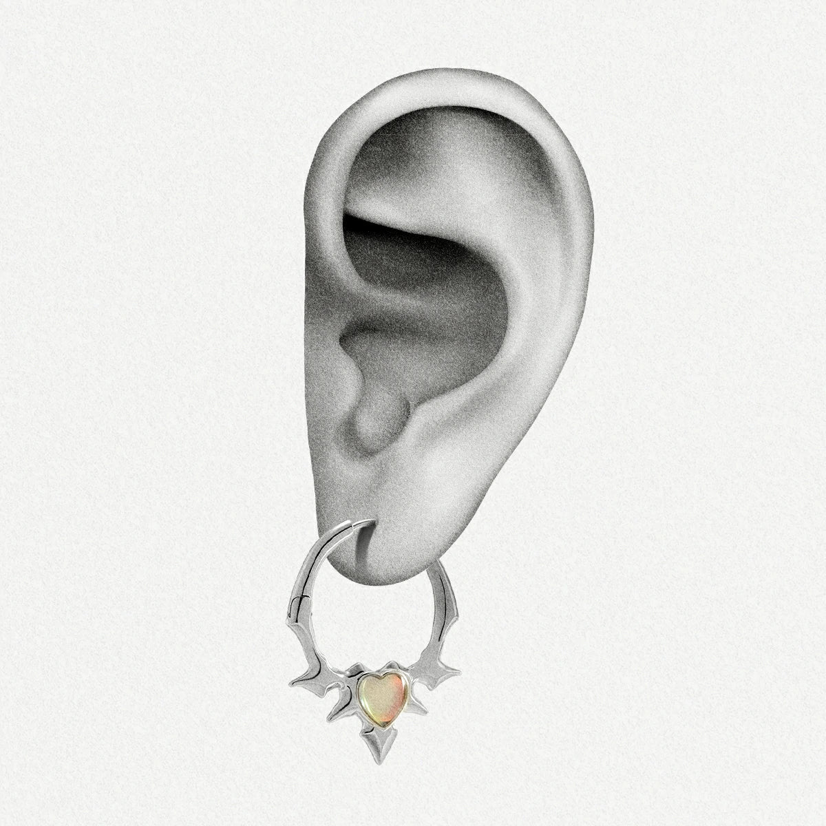 Silver-tone spiked hoop earring with an opal heart center worn on an ear illustration